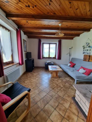 a living room with a couch and a table at La Mauselaine in Gerbépal