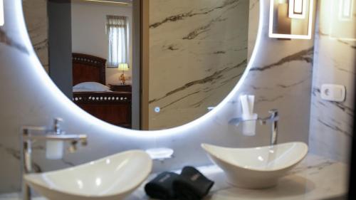 a bathroom with a sink and a large mirror at GF Luxury Villa with indoor pool -Afytos in Afitos