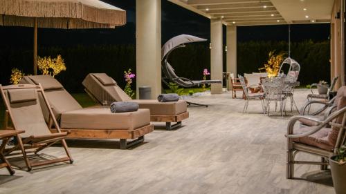 a lobby with several chairs and tables at GF Luxury Villa with indoor pool -Afytos in Afitos