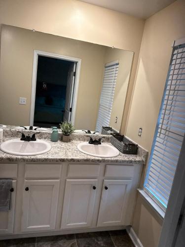 a bathroom with two sinks and a large mirror at 3bed townhouse in McDonough GA in McDonough