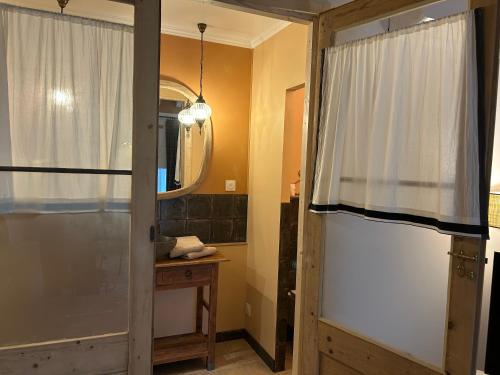 a bathroom with a shower and a glass door at L'Armandine in Saint-Marcel-Bel-Accueil
