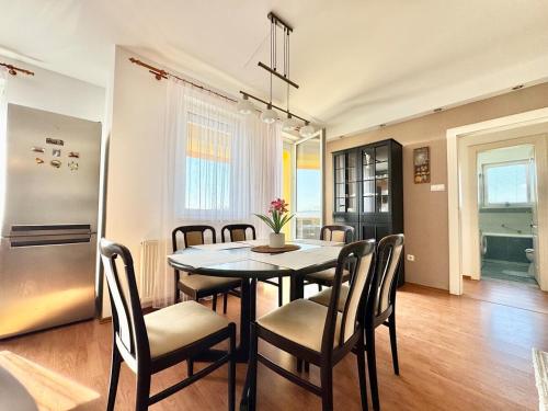 a kitchen and dining room with a table and chairs at Riverside Residence Free Parking in Dunakeszi