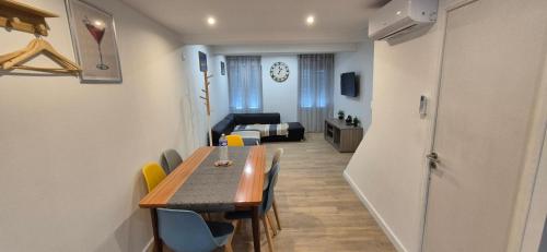 a dining room with a table and chairs and a couch at Maison à AY Epernay, 3 Bed Rooms House, 3 chambre in Ay