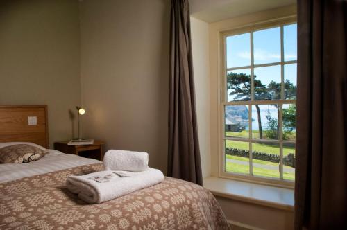 a bedroom with a bed and a window at Nant Gwrtheyrn in Llithfaen
