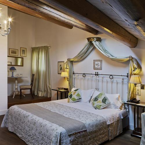 a bedroom with a large bed with a canopy at M Club De Luxe B&B in Ravenna