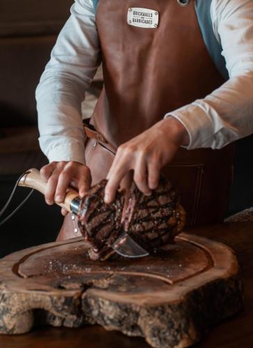 a man is using a brush on top of a table at Lodge Park in Megève