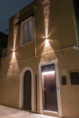 a building with lights on the side of it at EG House in Sarno