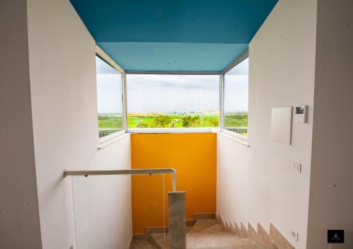 a room with a large window and a yellow door at Bed&BikeRome GALERIA ANTICA in Santa Maria di Galeria