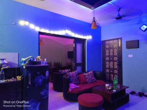 a living room with a couch and purple lighting at Ganges staycation in Nangi