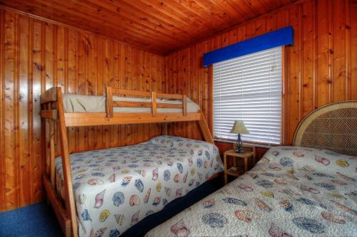 a bedroom with two bunk beds in a cabin at Averette Cottage by Carolina Beach Realty in Carolina Beach