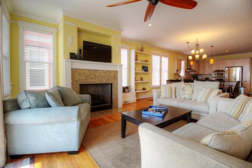 a living room with two couches and a fireplace at Banana Cabana by Carolina Beach Realty in Kure Beach