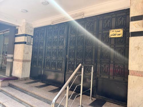 a beam of light shines on a large metal door at Nasr City Airport شقة فاخرة مدينة نصر in Cairo
