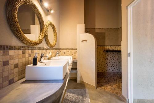 a bathroom with a sink and a mirror at The Baobab Bush Lodge and Villa in Hoedspruit