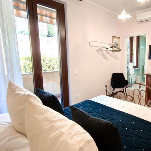 a bedroom with a bed and a table and a window at Villamena in Spello