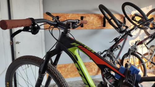 a bike parked in a garage next to a wall at Eco House San Michele in San Michele