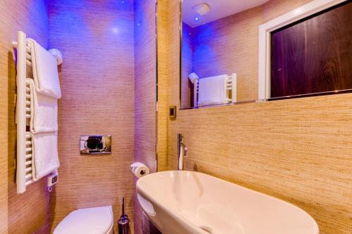 a bathroom with a white sink and a toilet at Hotel Villa d'Elsa in Juan-les-Pins