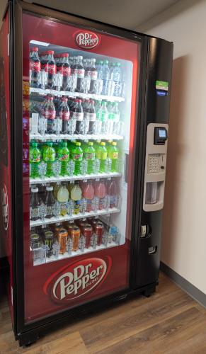 a soda vending machine with drinks in it at stayAPT Suites Madison-Greenbrier in Madison