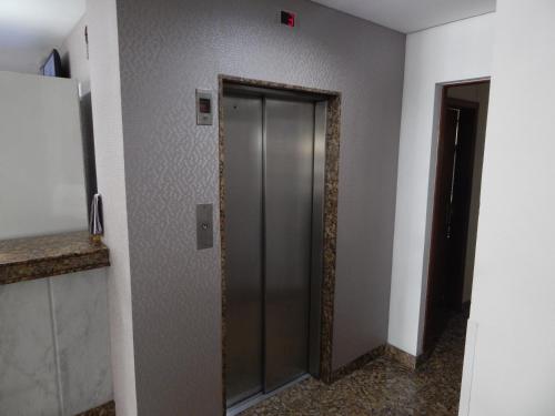 a elevator door in a room with a wall at Frimas Hotel in Belo Horizonte