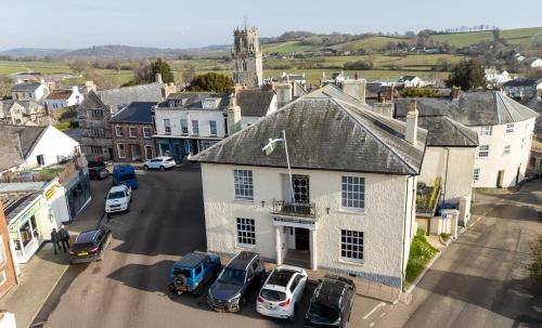 an aerial view of a small town with cars parked at Colcombe Castle Hotel in Colyton