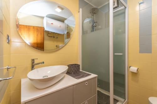 a bathroom with a sink and a mirror at Chalet Baranci in Pozza di Fassa