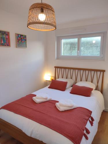 une chambre avec un grand lit blanc avec deux oreillers dans l'établissement Terra Marine - T2 - Centre ville, à Concarneau