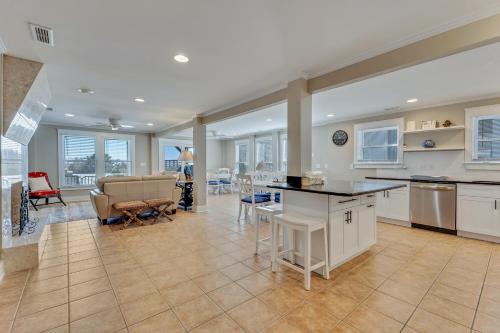 a kitchen and living room with a couch and a table at Boracay by Carolina Beach Realty in Kure Beach