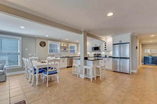 a kitchen with white appliances and a table and chairs at Boracay by Carolina Beach Realty in Kure Beach