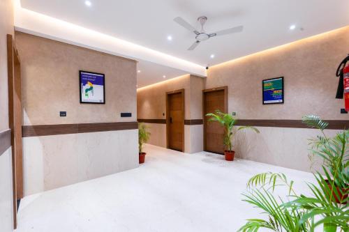 an office lobby with plants and a ceiling fan at Treebo SV Residency, Vellore in Vellore