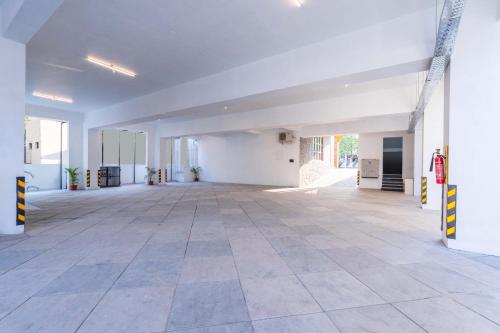 an empty room with white walls and a tile floor at Treebo SV Residency, Vellore in Vellore