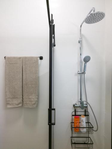 a shower in a bathroom with two towels at Mint Serenity Heraklio near InterClinic in Thérissos
