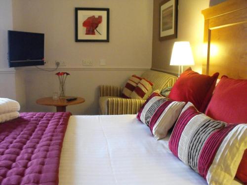 a hotel room with a bed and a couch at Gomersal Park Hotel & Bazaar Spa in Cleckheaton