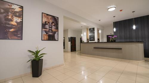a lobby with a reception desk and a potted plant at Forrest in Głogów Małopolski