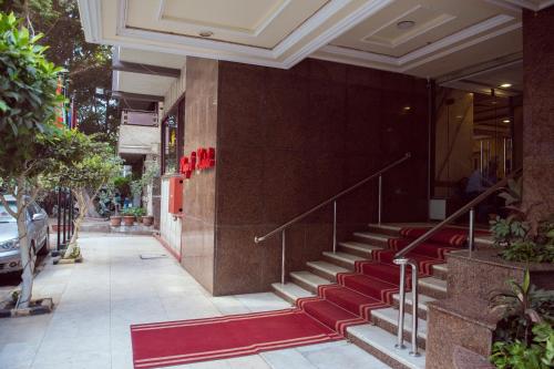 a building with red stairs and a red carpet at Salma Hotel Cairo in Cairo