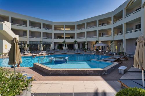 a hotel with a swimming pool and a resort at Pearl Beach in Rethymno Town