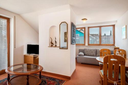 a living room with a table and a couch at Hotel Garni Vitamari in Wasserburg am Bodensee