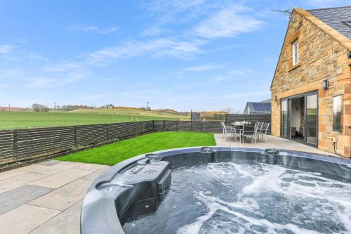 a hot tub in the backyard of a house at The Duchess - North East Escapes in Bamburgh