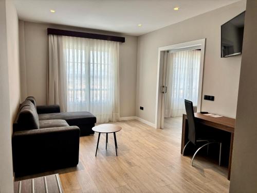 a living room with a couch and a table at ARVA Santiago León in León
