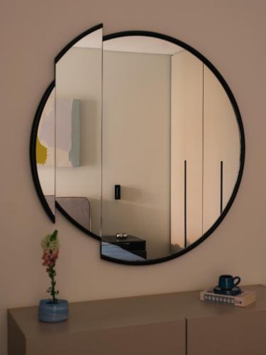 a large mirror on a wall in a bathroom at Brassbell Zamalek Diplomatic Zone Near Marriott in Cairo