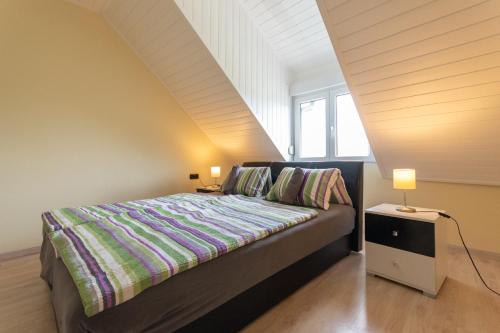 a bedroom with a bed and two lamps on a table at Sunny Beach in Zánka