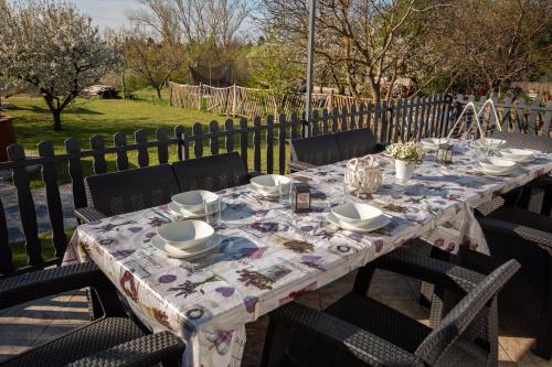 a table with chairs and a table cloth on it at Sunny Beach in Zánka