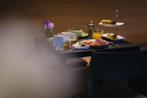 a breakfast table with a tray of food and drinks at Le Stanze del Lago Villa Seta in Como