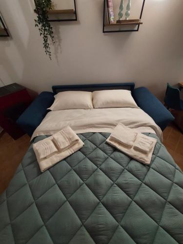 a bed with two towels on it in a room at LakeView Loft - Lago di Bolsena in Capodimonte