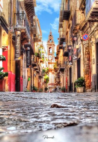 an empty street in a city with buildings at Massimo Rooms and suite in Palermo