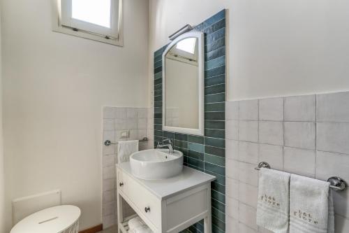 a bathroom with a sink and a toilet and a mirror at B&B Fiore in Gallipoli