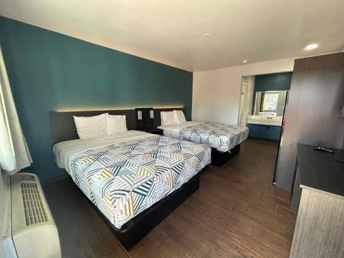 a hotel room with two beds and a window at Studio 6 Hemet, CA in Hemet