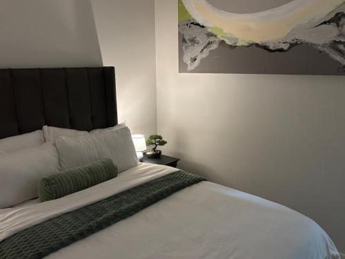 a bedroom with a large bed with a black headboard at Cozy nest apartment in Pretoria