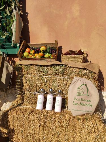 a box of fruit and a box of bottles at Eco House San Michele in San Michele