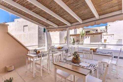a patio with tables and chairs on a balcony at B&B Fiore in Gallipoli