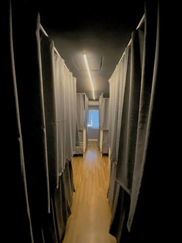 a hallway with a row of stalls in a building at Travelogue Guest House in Kuala Lumpur