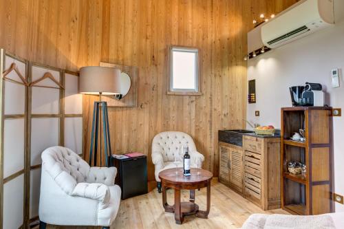 a living room with two chairs and a table at Coup 2 Foudres in Saint-Jean-de-Blaignac